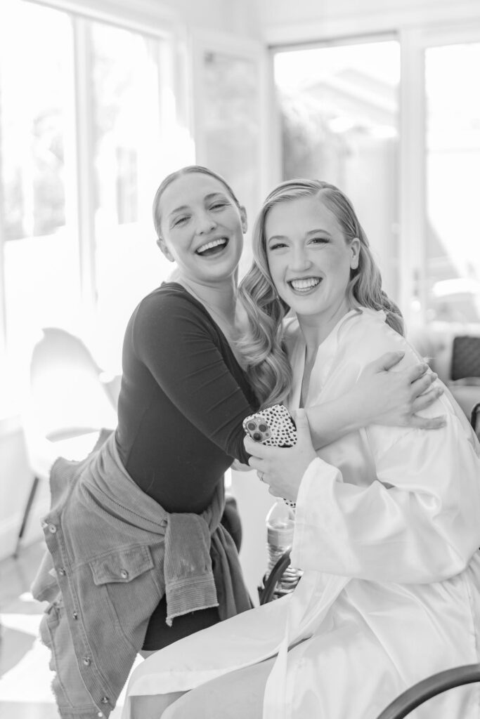 HMUA and bride laughing at camera.
