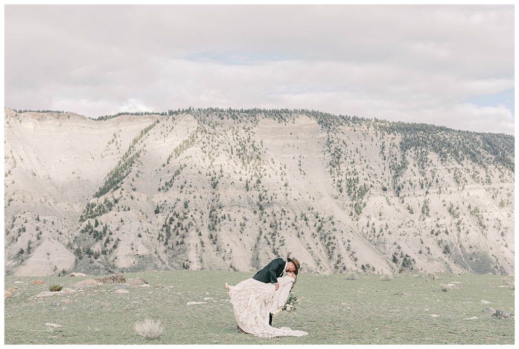 Groom dipping bride for portraits in Yellowstone Montana.