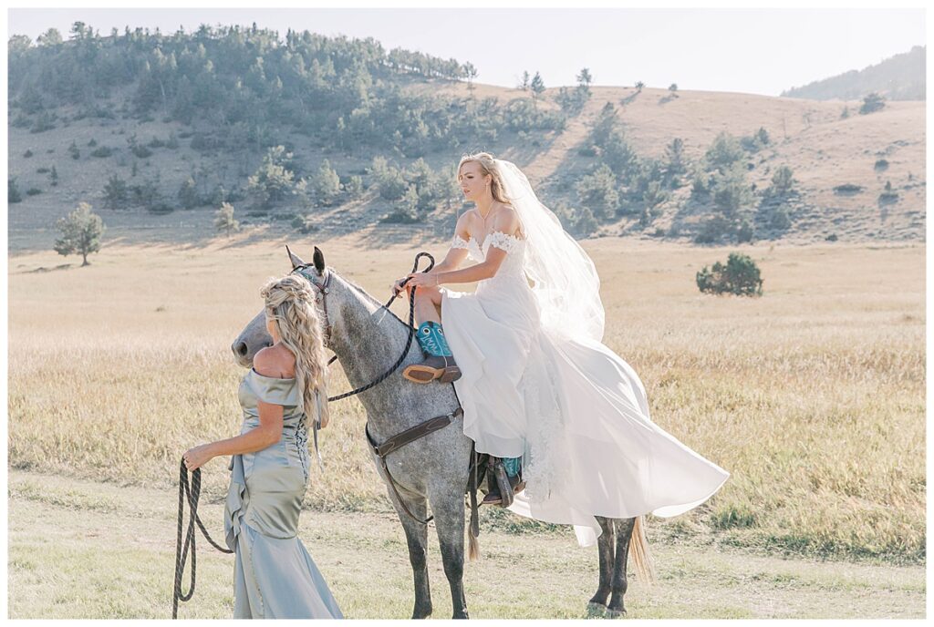 bride riding horse down the aisle during sunlight basin wedding