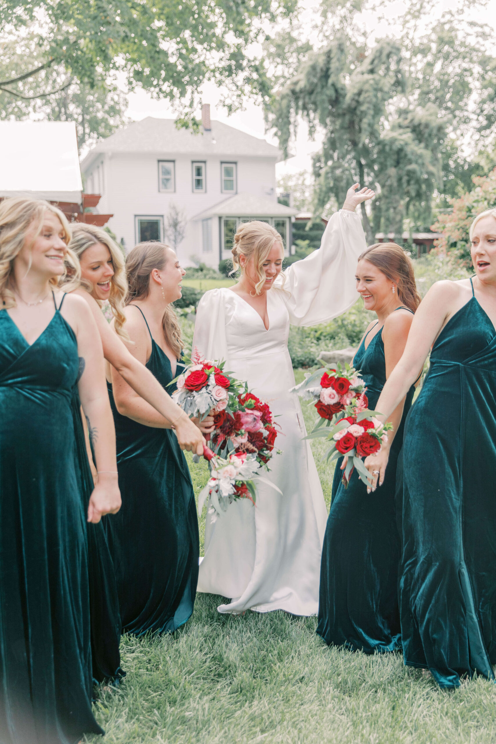 Bridesmaids dancing with bride on wedding day.